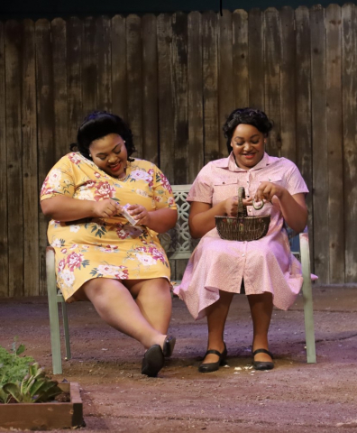 Two women sitting in chairs talking